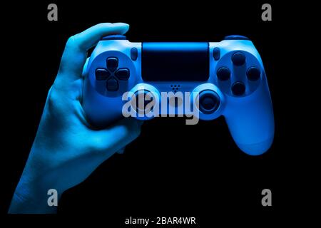 Hyman hand video game gamepad in neon lights isolated on a black background with clipping path Stock Photo