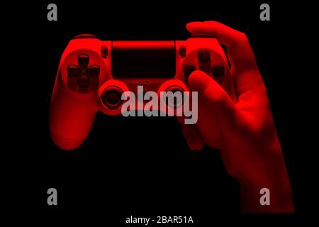 Hyman hand video game gamepad in neon lights isolated on a black background with clipping path Stock Photo