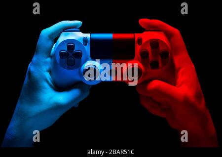 Hyman hands video game gamepad in neon lights isolated on a black background with clipping path Stock Photo