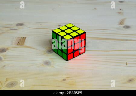 rubik's cube solved on wooden background Stock Photo