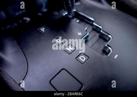 Automatic transmission gear, car interior. Automatic gear stick of a modern car, interior details, close up. Car detailing. Transmission lever Stock Photo