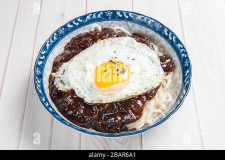 Jajangmyeon or jjajangmyeon is a Korean-style Chinese noodle dish topped with a thick sauce made of chunjang, diced pork, and vegetables. Stock Photo
