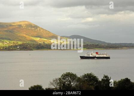 HEBRIDEAN PRINCESS at anchor in the delightfully peaceful setting of CARLINGFORD LOUGH, the sun shining on KNOCKSHEE, NORTHERN IRELAND Stock Photo