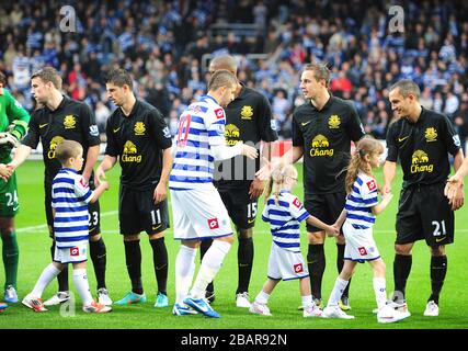 The two teams shake hands before kick-off Stock Photo