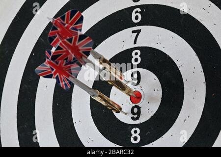 darts stuck into a target with circular sectors Stock Photo
