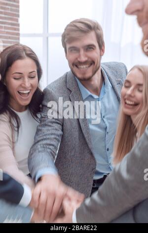 close up. happy business team joining their hands together. Stock Photo