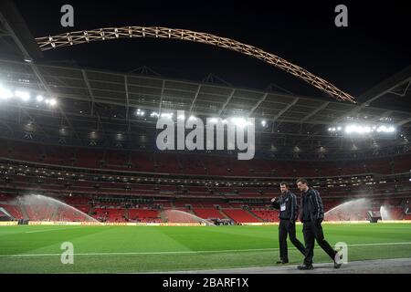 A general view of the Wembley pitch under sprinklers before the gamne Stock Photo