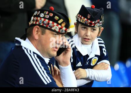 Scotland fans in the stands wearing hats with badges on Stock Photo