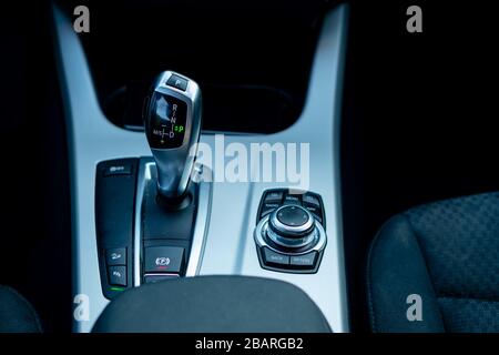 Automatic transmission gear, car interior. Automatic gear stick of a modern car, interior details, close up. Car detailing. Transmission lever Stock Photo