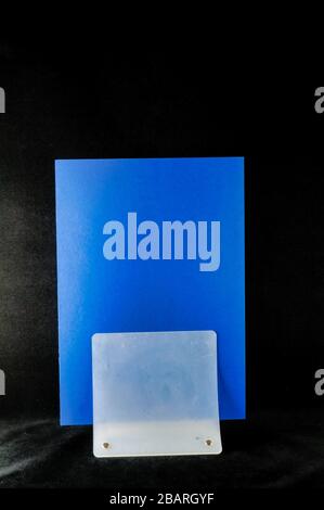 Vertical shot of blue and white rectangular surfaces behind each other Stock Photo