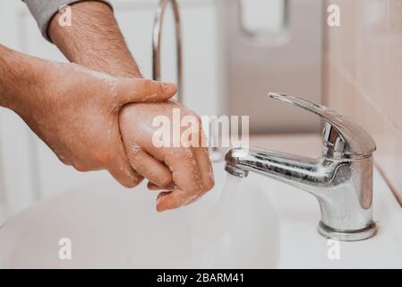 Washing hands rubbing with soap man for corona virus prevention, hygiene to stop spreading coronavirus. Stock Photo