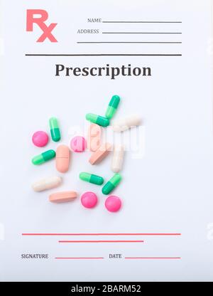 Medical prescription rx. Medicine pills, capsules and tablets on rx document background. Health pharmacy concept. Top vertical view Stock Photo