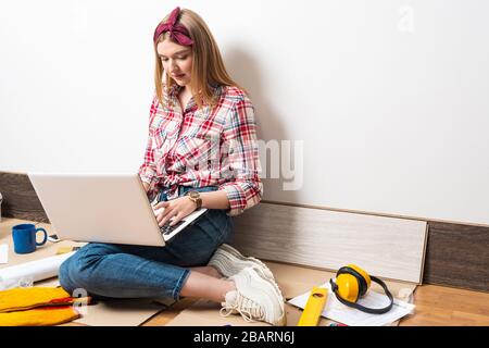 Beautiful girl using laptop computer at home Stock Photo