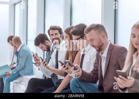 group of diverse young people sitting in the office lobby Stock Photo