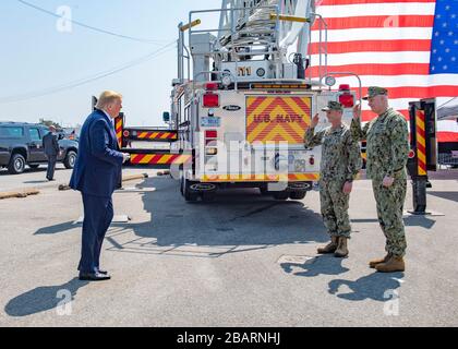 Norfolk, USA. 28th Mar, 2020. Norfolk, USA. 28 March, 2020. U.S Navy Adm. Christopher Grady, Commander, Fleet Forces Command and Naval Forces Northern Command, right, and Vice Adm. Woody Lewis, Commander, 2nd Fleet salute President Donald Trump during a visit to see off the Military Sealift Command hospital ship USNS Comfort at Naval Station Norfolk March 28, 2020 in Norfolk, Virginia. The Comfort is deploying to New York in support of the nation's COVID-19 response efforts. Credit: Mike DiMestico/U.S. Navy Photo/Alamy Live News Stock Photo