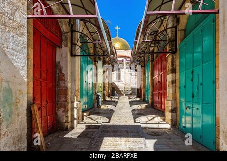 Colorful metal doors in a row as small church on background at famous market in old city of Jerusalem, Israel. Stock Photo