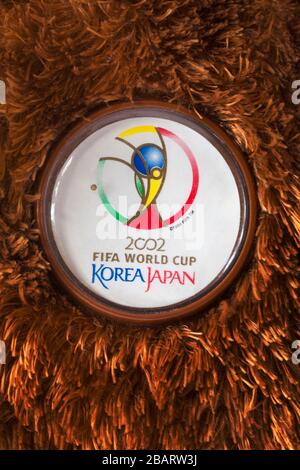 2002 Fifa World Cup Korea Japan pin badge on Champion the Fifa Beanie Buddy Germany the bear brown Ty Beanie Babies Buddies teddy bear soft cuddly toy Stock Photo
