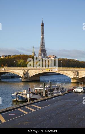 PARIS, FRANCE - NOVEMBER 7, 2019: Eiffel tower and bridge with Seine river view in a sunny autumn day in Paris, France Stock Photo