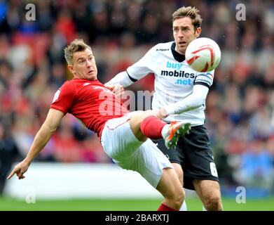 Nottingham Forest's Simon Cox and Derby County's Richard Keogh battle for the ball Stock Photo