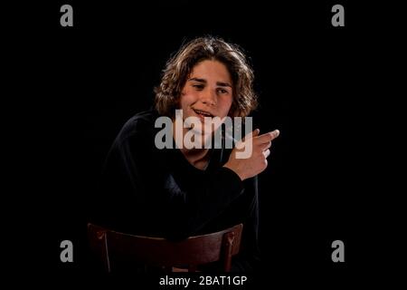 Trendy handsome man posing in trendy black turtleneck polo sweater Stock Photo