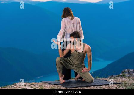 Two athletic young dancers making a performance at mountain peak Stock Photo