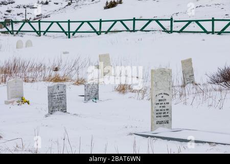 Churchyard cemetery for Our Lady of the Snows, a Roman Catholic church in Fogo, on Fogo Island in Newfoundland, Canada Stock Photo