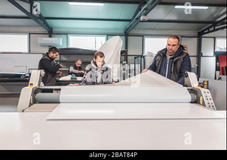 Large group of worker printmaker technician operator works in digital ...