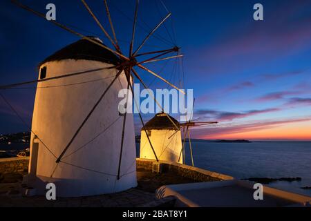 Traditional greek windmills on Mykonos island at sunrise, Cyclades, Greece Stock Photo