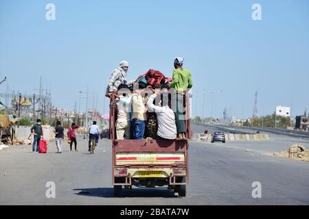 Migrant workers travelling in the back of a truck during the nationwide lock down.The Indian government imposed a 21 day nationwide lock down as a preventive measure against the corona virus pandemic. Stock Photo