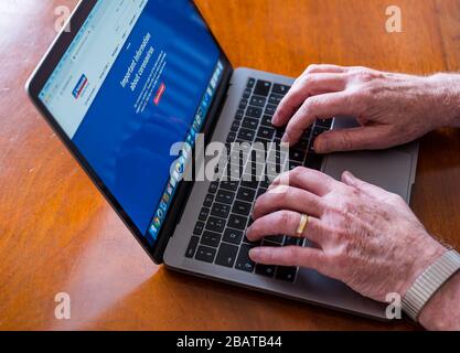 Senior man hands working on a laptop. Nationwide Building Society website and Coronavirus customer information, UK Stock Photo