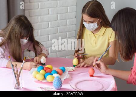 Quarantined sick family paints eggs for Easter Stock Photo