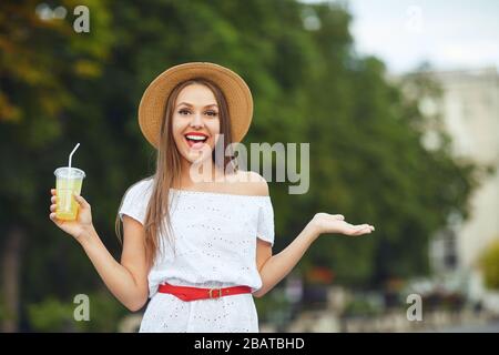 Woman young pretty blonde in a hat on the street city. Stock Photo