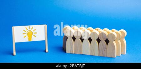 Business team and easel with the image light bulb of an idea. Generating Innovative Ideas. Creative business process. Strategy and Management. Teamwor Stock Photo
