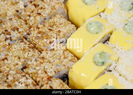 Sushi and rolls home delivery. Krpny plan. Sesame, salmon, cheese. Stock Photo