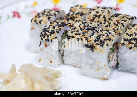 Sushi and rolls home delivery. Krpny plan. Sesame, salmon, cheese. Stock Photo