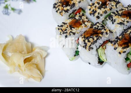 Sushi and rolls home delivery. Krpny plan. Sesame, salmon, cheese. Stock Photo