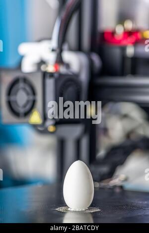 white plastic model of egg printed on a 3D printer. modern technology. Stock Photo