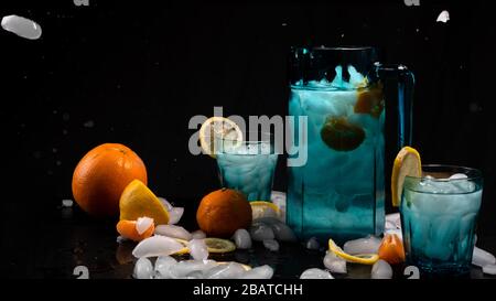 Refresh water cocktail on black background. Oranges, mandarin, lemons on black background. Stock Photo