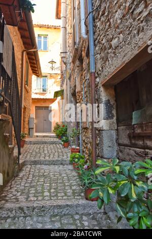 A narrow street between the stone houses of Prossedi, a medieval village in the Lazio region, Italy Stock Photo