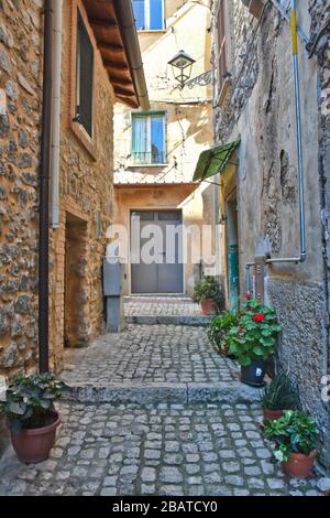 A narrow street between the stone houses of Prossedi, a medieval village in the Lazio region, Italy Stock Photo