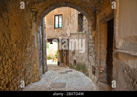 A narrow street between the stone houses of Prossedi, a medieval village in the Lazio region, Italy Stock Photo