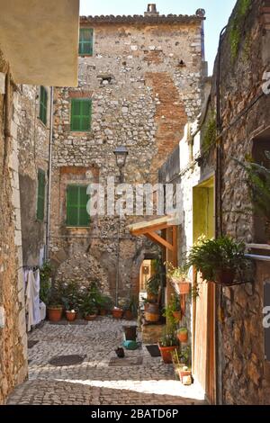 A narrow street between the stone houses of Prossedi, a medieval village in the Lazio region, Italy Stock Photo