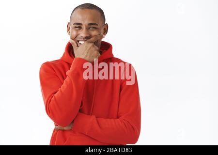 Close-up portrait of carefree, happy african-american man, laughing and smiling, having conversation with friend, watching funny movie or comedy show Stock Photo