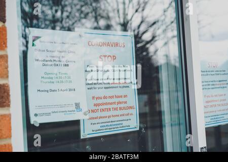 Coronavirus notice on door at GP surgery, Oxfordshire UK Stock Photo