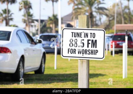 Sign in a Drive-In Church to tune the Car Radio to Worship in Daytona Beach, Florida, USA Stock Photo