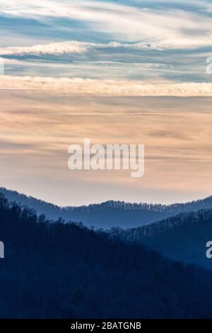 Contrails and clouds make interesting designs in the sky at the Tanbark Ridge Overlook on the Blue Ridge Parkway in Asheville, NC, USA. Stock Photo