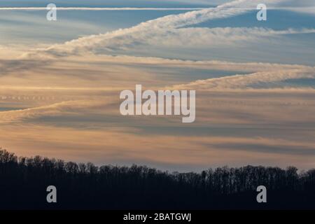 Contrails and clouds make interesting designs in the sky at the Tanbark Ridge Overlook on the Blue Ridge Parkway in Asheville, NC, USA. Stock Photo