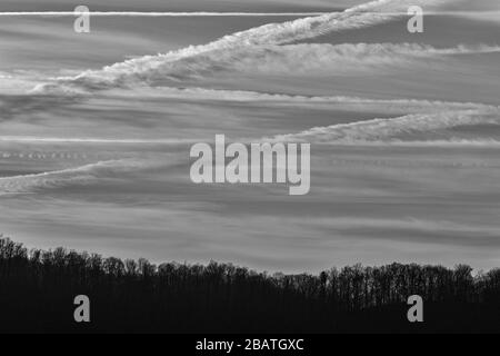 Contrails and clouds make interesting designs in the sky at the Tanbark Ridge Overlook on the Blue Ridge Parkway in Asheville, NC, USA. Stock Photo