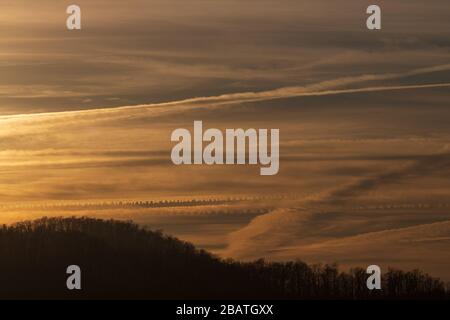 Contrails and clouds make interesting designs in the sky at the Tanbark Ridge Overlook on the Blue Ridge Parkway in Asheville, NC, USA. Stock Photo