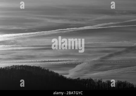 Contrails and clouds make interesting designs in the sky at the Tanbark Ridge Overlook on the Blue Ridge Parkway in Asheville, NC, USA. Stock Photo